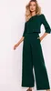 A woman modeling a green jumpsuit. Anteprima dell’immagine prodotto