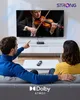 A couple is sitting on a couch watching TV, with a streaming device on the TV stand. Voir les images du produit