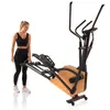 A woman is standing next to a HAMMER Ellipsentrainer CrossPace 5.0 NorsK. Podgląd zdjęcia produktu