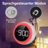 A digital alarm clock with a glowing ring is shown on a table next to a decorative house. The image also features icons and text explaining features of the clock. Produktbild-Vorschau