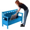 A woman is placing a cushion into a blue wooden storage bench. Anteprima dell’immagine prodotto