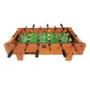 A tabletop foosball game with red and yellow players on a green field, set against a white background. Náhled obrázku produktu