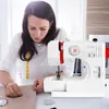 A woman is sewing with a white sewing machine. Produktbild-Vorschau