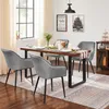 A dining room scene with a table set for a meal and chairs around it. Produktbild-Vorschau