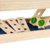 Close-up view of wooden planks with holes and green screw heads, part of a toy workbench. Náhled obrázku produktu