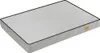A light gray dog bed with black piping around the edges, shown from a slightly elevated angle on a white background. A small, light brown tag with text is visible on the right side of the bed. Náhled obrázku produktu