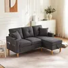 A dark gray sectional sofa with a chaise lounge is shown in a well-lit room with white walls and decorative molding. Podgląd zdjęcia produktu