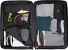 An open suitcase packed with clothing and accessories. Anteprima dell’immagine prodotto