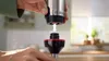 A person is shown assembling a kitchen appliance. Produktbild-Vorschau