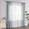 A window with sheer curtains, a nightstand with a vase of tulips, and a plant. Produktbild-Vorschau