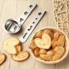 A close-up shot of cookie cutters and palmiers cookies on a wooden surface. Produktbild-Vorschau