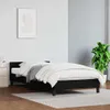 A bedroom scene with a black bed frame and white bedding. Náhled obrázku produktu