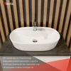 A white ceramic sink with a chrome faucet is shown on a dark gray countertop, with a slatted wooden wall in the background. Text overlays provide product information. Produktbild-Vorschau