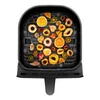 A top-down view of an air fryer basket filled with various dried fruits. Produktbild-Vorschau