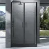 A modern black framed shower enclosure with frosted glass doors, set against a backdrop of a concrete wall and a large window overlooking a natural landscape with mountains and trees. Produktbild-Vorschau