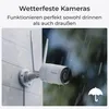 A security camera mounted on a wall in the rain, with text indicating it is weatherproof. Produktbild-Vorschau