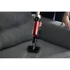 A person is using a cordless vacuum cleaner on a gray fabric sofa. Produktbild-Vorschau