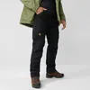 A person wearing outdoor clothing, including a green jacket and black cargo pants, standing against a white background. Produktbild-Vorschau