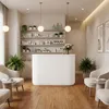 A clean and modern reception desk in a salon or spa setting, with shelves stocked with products and seating areas. Produktbild-Vorschau