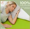 A woman sleeping on a pillow with a green background. Produktbild-Vorschau