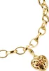 A close-up shot of a gold charm bracelet with a heart-shaped charm. Náhled obrázku produktu