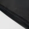 A close-up view of the seam and fabric of a black garment. Náhľad obrázku produktu
