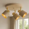 A close-up shot of a three-light ceiling fixture mounted on a ceiling. Produktbild-Vorschau