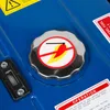 A close-up view of a blue generator with a fuel cap and warning labels. Anteprima dell’immagine prodotto