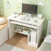 A white computer desk with a monitor, keyboard, and computer tower, set up in a room with light green walls and a window seat. Produktbild-Vorschau