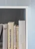 A close-up view of several books on a shelf. Produktbild-Vorschau