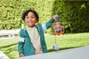 A young boy is playing with a toy helicopter outdoors. Anteprima dell’immagine prodotto