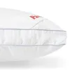 A close-up view of a white pillow with blue stitching. Produktbild-Vorschau