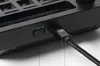 Close-up of the side of a black electronic device, showing a USB-C port and a switch. Produktbild-Vorschau