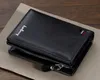 A black leather wallet is placed on a textured surface. Podgląd zdjęcia produktu