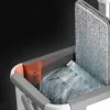 A close-up view of a mop bucket with a mop head being inserted, showing a measurement indicator. Náhľad obrázku produktu