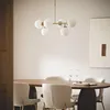 A dining room scene with a table, chairs, and a chandelier. Produktbild-Vorschau