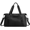 A black duffel bag is shown against a white background. Voir les images du produit