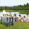 A family is having a picnic by a lake, with a foldable wagon filled with picnic items. Produktbild-Vorschau