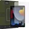 A screen protector is shown placed over an iPad screen, with the product packaging visible to the left. Náhled obrázku produktu