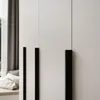 A close-up view of a modern wardrobe with black handles. Produktbild-Vorschau