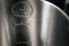 A close-up view of the inside of a stainless steel kettle, showing embossed markings. Produktbild-Vorschau