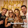 Four people posing for a photo with New Year's Eve decorations. Anteprima dell’immagine prodotto
