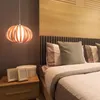 A bedroom scene with a bedside table, bed, and a hanging lamp. Náhled obrázku produktu