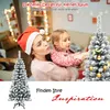 A woman in a Santa hat holds a young girl, and they are decorating a flocked Christmas tree. Another flocked Christmas tree is shown on the left. Produktbild-Vorschau