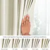 A hand is shown parting a cream-colored curtain, with a series of smaller images below demonstrating the curtain's appearance under different lighting conditions. Podgląd zdjęcia produktu
