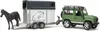 A toy Land Rover Defender towing a horse trailer with a toy horse. Produktbild-Vorschau