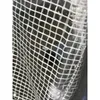 A close-up view of a white grid pattern on a clear plastic material, likely part of a greenhouse. Voir les images du produit