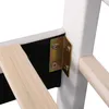 A close-up view of the corner of a bed frame, showing a metal bracket connecting a wooden slat to a white upholstered post. Produktbild-Vorschau