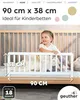A child is sitting on a bed with a white bed guard rail in front of her. Produktbild-Vorschau