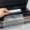 A hand is shown placing a vacuum seal bag into a vacuum sealer machine. Anteprima dell’immagine prodotto